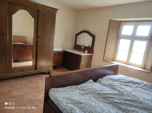a bedroom with a bed and a sink and a mirror at Schwalbennest 