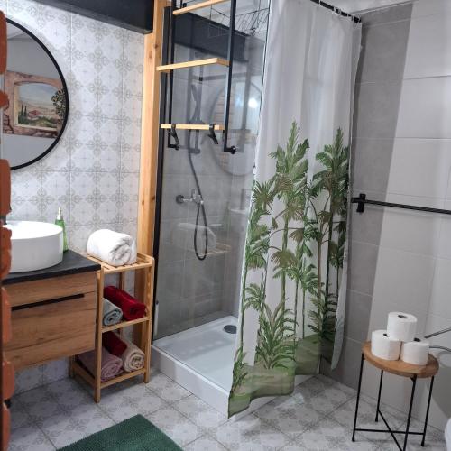 a bathroom with a shower with plants on the shower curtain at Silnowo Kwietny Raj in Silnowo