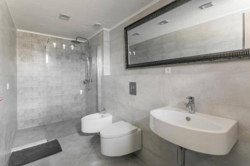 a bathroom with a sink and a toilet and a mirror at Marso in Krašići