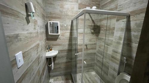 a bathroom with a shower and a sink at Casa Velha Hospedagem Jacuípe in Camaçari