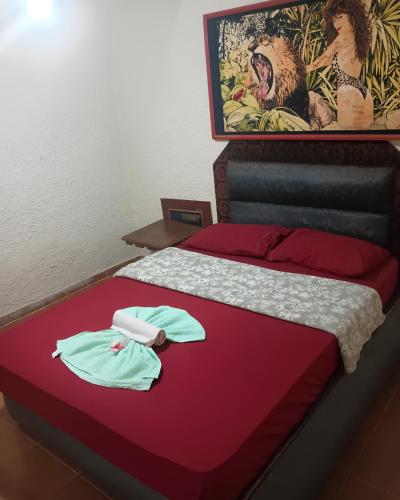a bed with two robes on top of it at Motel carioca in Miguel Pereira