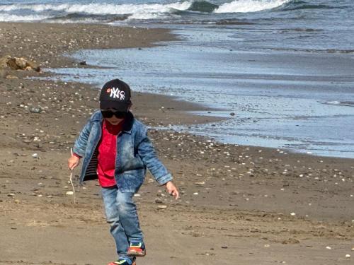 a young child walking on the beach at Playa 7 in Martil