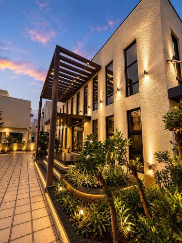 a building with a courtyard with plants in front of it at Hotel bella rosa in Chengalpattu