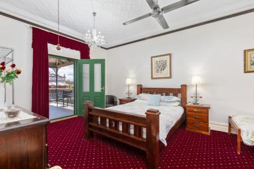 a bedroom with a bed and a table and a window at Tall Timbers Motel in Dungog