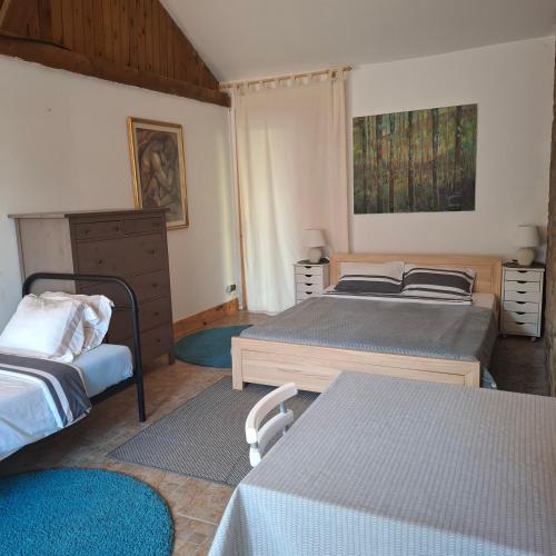a bedroom with two beds and a dresser at Silnowo Kwietny Raj in Silnowo