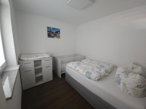 a small room with a bed and a night stand at Traumwohnung Füssen 14 in Füssen