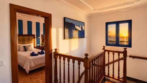 a staircase leading to a bedroom with a bed at Verde Mar, vive el oceano en primera linea in La Santa