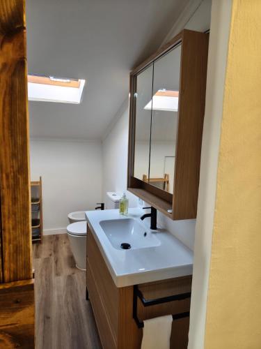 a bathroom with a sink and a toilet at The Cherry Tree Place in Góis