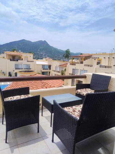 a patio with chairs and tables on a balcony at Acapulco Diamante - Playa Princess & GNP Arena in Acapulco