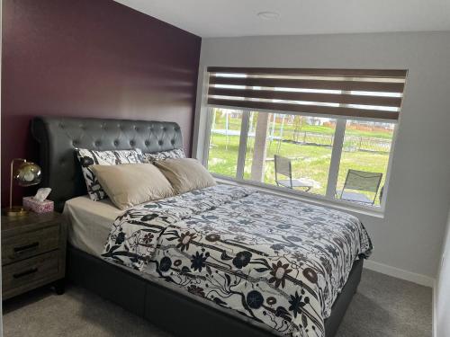 a bedroom with a bed and a window at Lakeview 2Bedroom Walkout Suite with Trail View in Winnipeg