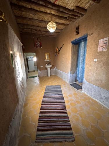 a room with a rug on the floor of a building at Guest House For Rent Merzane in Merzane