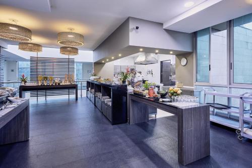 a large kitchen with a counter with food on it at Hotel bh El Poblado in Medellín