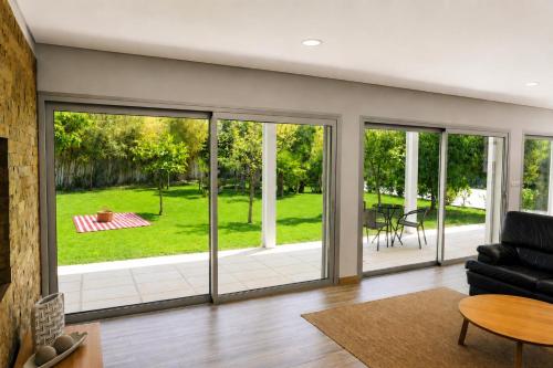 a living room with sliding glass doors at Casa da Tapada - Grupo Casas Vale do Lima in Ponte de Lima