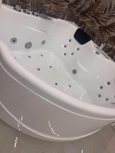 a white bath tub sitting in a bathroom at Romantic Suite Genova in Genoa