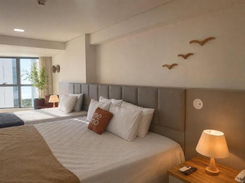 a bedroom with two beds with birds on the wall at Luxo na Beira Mar - Beach Class Executive 105 in Recife