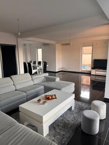 a living room with a couch and a table at Villa Pazar na dlanu in Novi Pazar