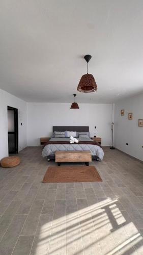 a bedroom with a bed and a table in it at LA SIESTA Suites in Huarmey