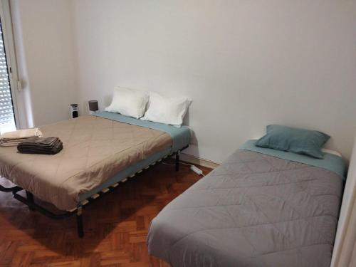 two beds sitting next to each other in a room at The Tram 18 Space in Lisbon