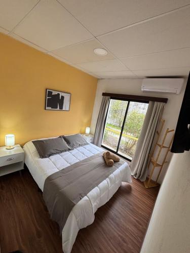a bedroom with a large bed and a large window at La Casona Posada in Florencio Sánchez