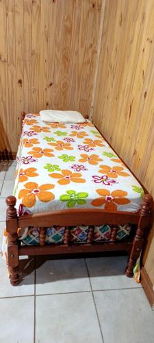 a bed sitting in a corner of a room at Cabaña Don Jorge in Puerto Rico