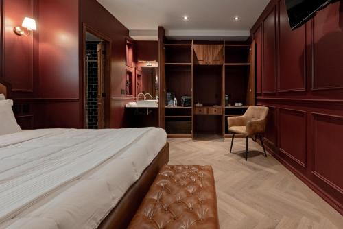 a bedroom with a bed and a desk and a chair at The Urban Muse suite in Mexico City