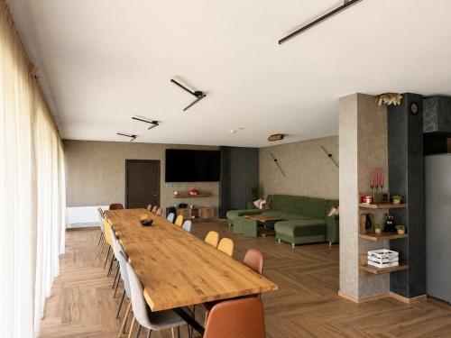 a conference room with a large wooden table and chairs at Gracia House in Mogilovo