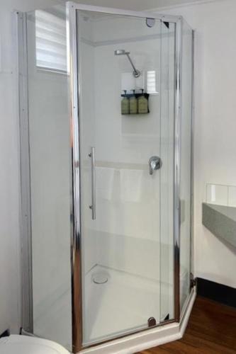 a shower with a glass door in a bathroom at BIG4 Tasman Holiday Parks - Warrnambool in Warrnambool