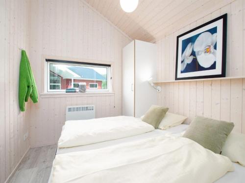 a room with two beds and a window at Grobenbrode Split-Wing House in Grossenbrode