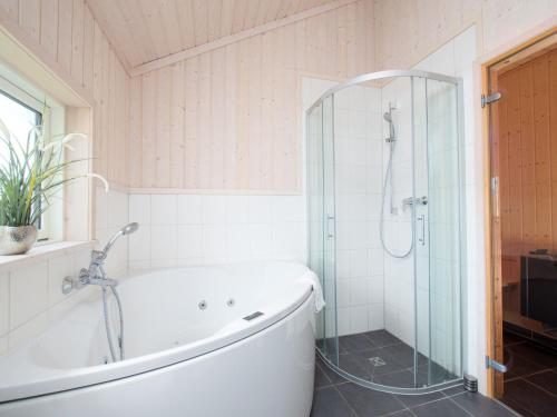 a bathroom with a tub and a shower at Spa Residence near Shore in Grossenbrode