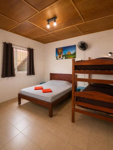 a bedroom with a bed and a bunk bed at Bananoz Surfhouse in Transito