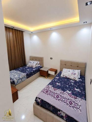 a bedroom with two beds and a couch at Portogolf elalamin in El Alamein
