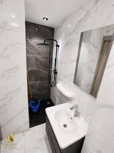 a white bathroom with a sink and a shower at Portogolf elalamin in El Alamein