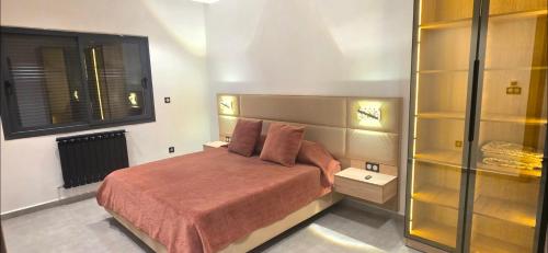 a small bedroom with a bed and a window at Luxury Apartment in Tlemcen