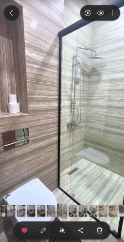a shower in a bathroom with a mirror at Luxury Apartment in Tlemcen