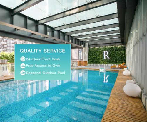 a pool at a hotel with a sign that reads quality service floor front at Rhombus Park Aura Chengdu Hotel in Chengdu