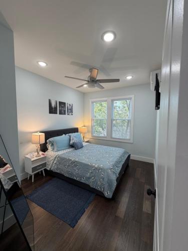 a bedroom with a bed and a ceiling fan at Modern & Spacious Apartment 15 Min to NYC Near MetLife & American Dream in Jersey City