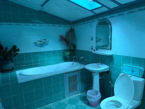 a bathroom with a tub and a toilet and a sink at Benny sweet family in Ao Phutsa