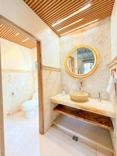 a bathroom with a sink and a mirror at Tritonia Island Tintipán in Tolú
