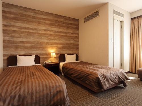 Posteľ alebo postele v izbe v ubytovaní Ohito Hotel