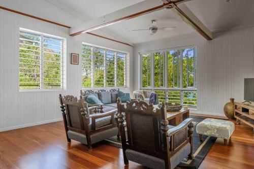 a living room with a couch and some windows at Driftwood in Picnic Bay