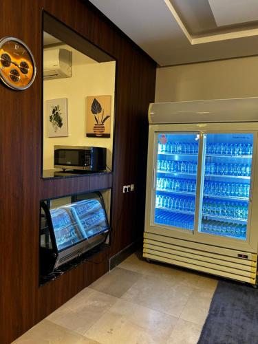 a refrigerator filled with lots of water and a window at سما حقل للشقق المخدومه in Al Humaizah