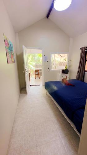 a bedroom with a blue bed in a room at Nomad house in Hin Kong in Ko Phangan