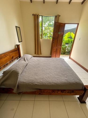 a bedroom with a bed and a large window at Costa Rica Backpackers in San José