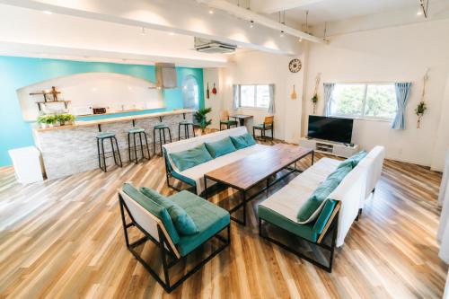 a living room with a couch and a table and chairs at Small Resort 志摩 in Shima