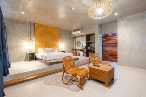 a bedroom with a bed and a table and chairs at Cebu R Resort Tabuelan in Tabuelan