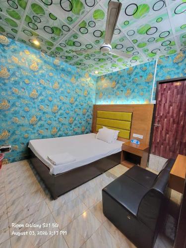 a bedroom with a bed and a couch in it at Hotel The One Point, Uttara in Bāiljuri