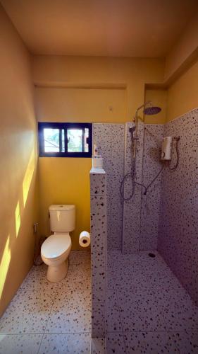 a bathroom with a toilet and a shower at One bedroom apartment Hin Kong in Ko Phangan