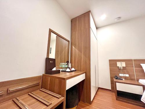 a bathroom with a sink and a mirror at Paragon Noi bai Hotel & Pool in Thach Loi