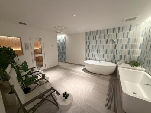 a large bathroom with a tub and a sink at Olympic Inn Azabu in Tokyo