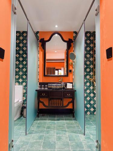 a bathroom with a sink and a mirror at Spatel d'Annam - Imperial Boutique Spa & Hotel in Hue